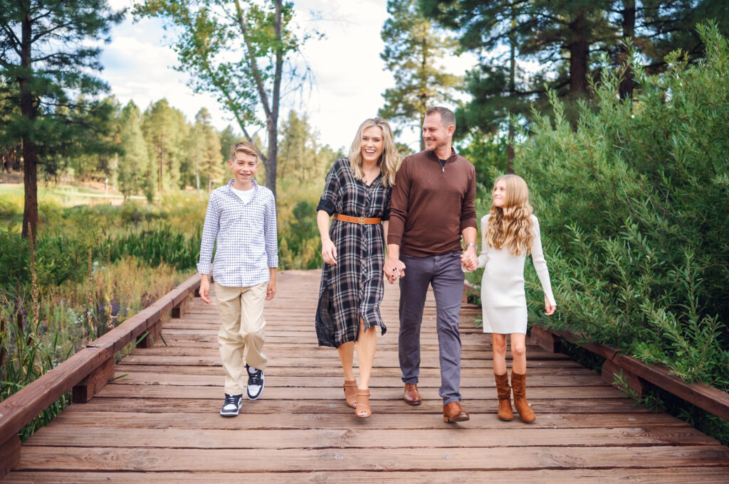 a group of people walking on a wooden bridge in Showlow, Arizona